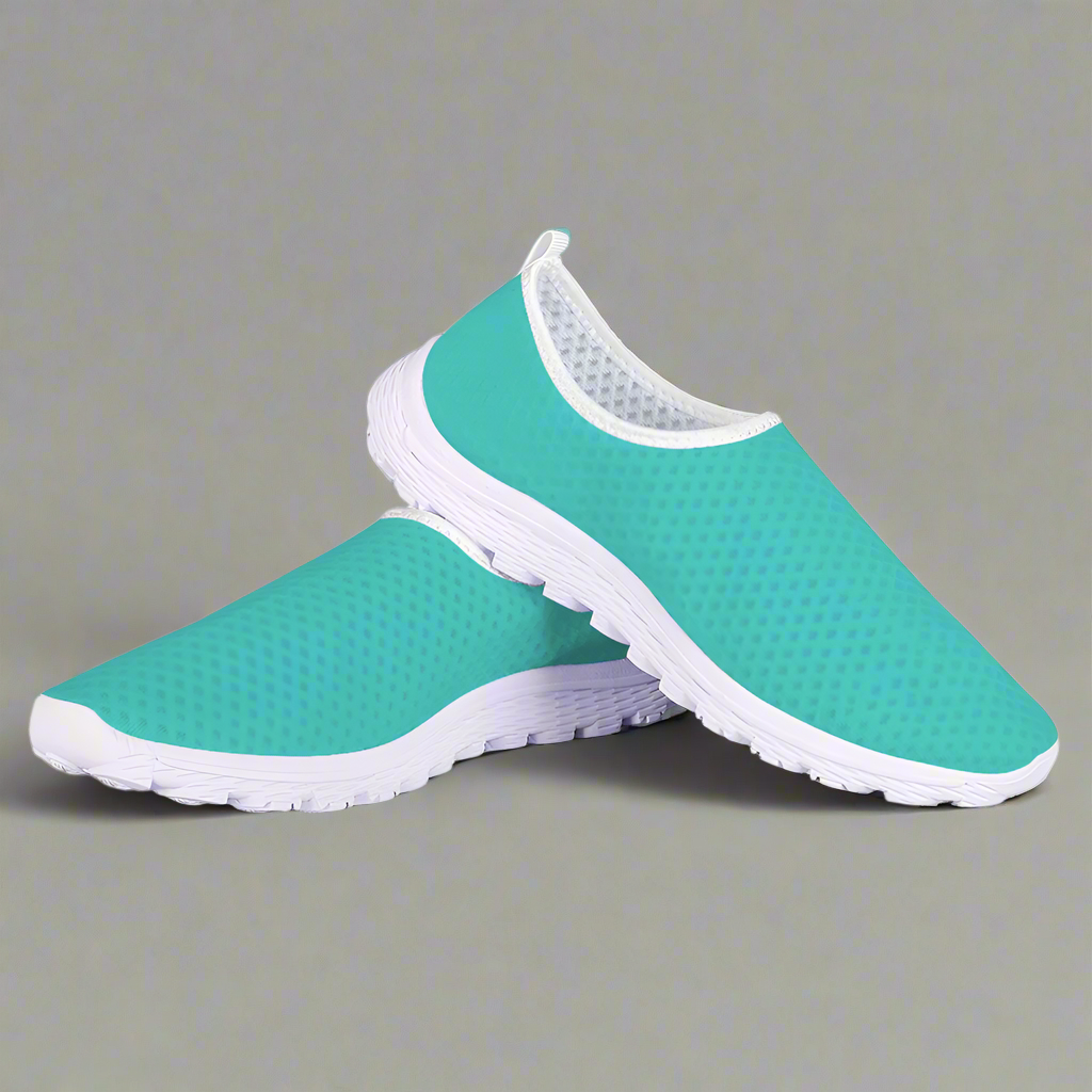 The She's a Vibe 40 Cushion Kicks in teal showcases a breathable mesh upper and a sleek white sole, blending comfort with style.