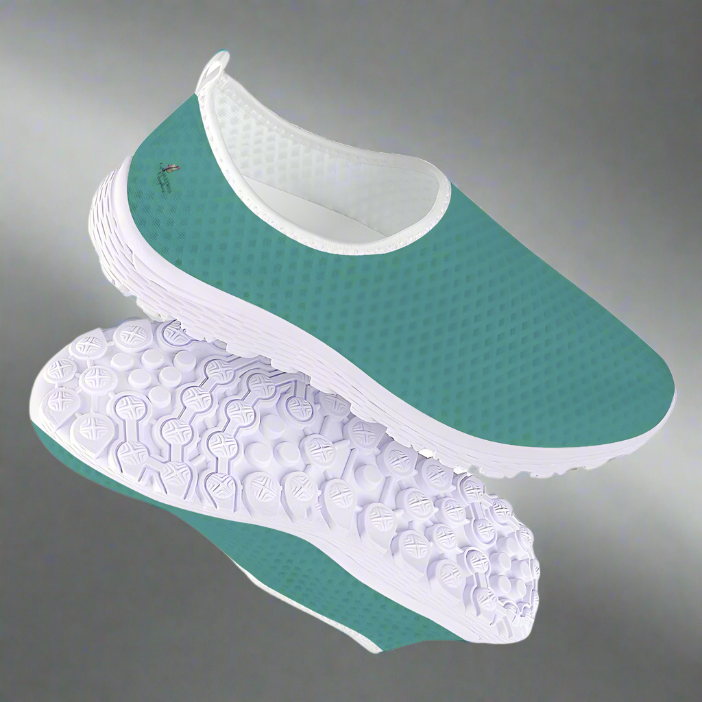 The Next Level Cushion Kicks, featuring a teal slip-on design with a textured mesh upper and white sole, are stylishly showcased against a pristine white background.