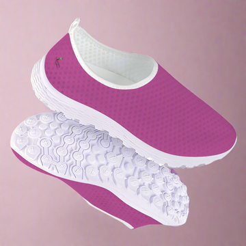 The Melanin Love Cushion Kicks are stylish slip-on sneakers in pink, featuring a slip-resistant white sole and a perforated mesh fabric design.