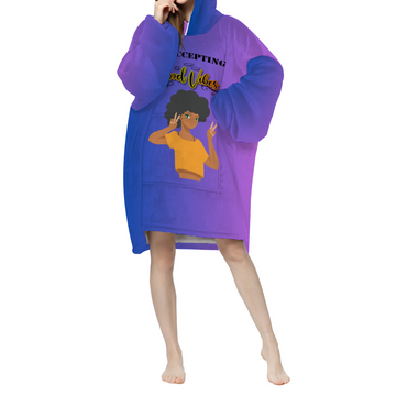 A woman wearing a Now Accepting Good Vibes Purple Adult Long Sherpa Hooded Blanket.